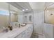 Bright bathroom features a glass enclosed shower and a vanity with double sinks at 4355 Pompano Ln, Palmetto, FL 34221