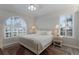Neutral bedroom featuring white decor, large windows, and carpeted floors at 4355 Pompano Ln, Palmetto, FL 34221