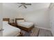 Cozy bedroom featuring two twin beds, a ceiling fan, and neutral decor creating a relaxing atmosphere at 4355 Pompano Ln, Palmetto, FL 34221