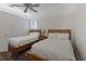 Well-lit bedroom with two beds, a nightstand, ceiling fan, and a bright window for a comfortable feel at 4355 Pompano Ln, Palmetto, FL 34221