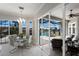 Bright dining area featuring a glass table and sliding glass doors to the screened in outdoor lounge area at 4355 Pompano Ln, Palmetto, FL 34221