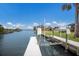 A waterfront home featuring a private boat dock on the canal with a boat lift and lovely views at 4355 Pompano Ln, Palmetto, FL 34221