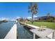 A waterfront home featuring a private boat dock on the canal with a boat lift, sink and palm tree views at 4355 Pompano Ln, Palmetto, FL 34221