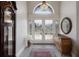 Elegant foyer with chandelier, decorative glass doors, tile flooring, and stylish furnishings at 4355 Pompano Ln, Palmetto, FL 34221