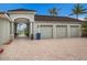 Home with a paved driveway, tropical landscaping and a three-car garage plus a covered walkway to the main house at 4355 Pompano Ln, Palmetto, FL 34221