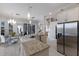 Open-concept kitchen featuring granite countertops, stainless appliances, a dining area, and access to a living area at 4355 Pompano Ln, Palmetto, FL 34221