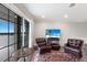 Elegant living room with leather chairs, a stylish area rug, and a view to complement the interior at 4355 Pompano Ln, Palmetto, FL 34221