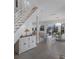 Inviting living room with a staircase, a console table, and an open-concept design leading to the dining area at 4355 Pompano Ln, Palmetto, FL 34221