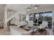 Open-concept living room with staircase, pool views, and comfortable seating arrangement at 4355 Pompano Ln, Palmetto, FL 34221