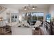 Bright and airy living room featuring a view of pool area and staircase to the second floor at 4355 Pompano Ln, Palmetto, FL 34221