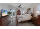 Main bedroom with four-poster bed, dresser, and access to patio and pool at 4355 Pompano Ln, Palmetto, FL 34221