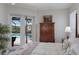 Main bedroom features a large bed with patio access overlooking a screened pool area at 4355 Pompano Ln, Palmetto, FL 34221