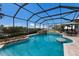 Screened pool area with waterfall feature, spa, and seating area, perfect for relaxing outdoors at 4355 Pompano Ln, Palmetto, FL 34221
