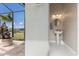 Elegant powder room features a pedestal sink, decorative mirror, and neutral decor at 4355 Pompano Ln, Palmetto, FL 34221