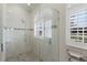 Close up of the glass shower, featuring bright, neutral-toned tile and updated fixtures at 4355 Pompano Ln, Palmetto, FL 34221