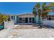 Exterior backyard view with a covered patio, brick flooring, a waterfront canal and boat docks at 444 63Rd St, Holmes Beach, FL 34217