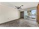 Living room featuring water view with large glass sliding doors, ceiling fan and white ceiling at 444 63Rd St, Holmes Beach, FL 34217