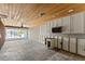 Spacious living room featuring water view with large glass sliding doors and wood plank ceiling at 444 63Rd St, Holmes Beach, FL 34217