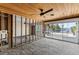 Spacious living room featuring water view with large glass sliding doors, ceiling fan and wood plank ceiling at 444 63Rd St, Holmes Beach, FL 34217