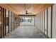 Spacious living room featuring water view with large glass sliding doors, ceiling fan and wood plank ceiling at 444 63Rd St, Holmes Beach, FL 34217