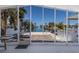 Covered outdoor patio with brick flooring leading to a canal view at 444 63Rd St, Holmes Beach, FL 34217