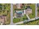 Aerial view of a property with a pool, patio, landscaping, and solar panels on the roof at 4440 Yacht Club Dr, Venice, FL 34293
