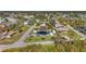Birds eye view of homes with well-manicured lawns and mature trees in a peaceful residential area at 4440 Yacht Club Dr, Venice, FL 34293