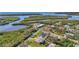 A scenic aerial view of waterfront homes surrounded by lush greenery and serene waterways in a coastal community at 4440 Yacht Club Dr, Venice, FL 34293