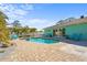 Backyard with pool, spa, patio and lawn chairs at 4440 Yacht Club Dr, Venice, FL 34293