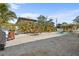 Backyard brick patio with dining set overlooking the pool and lush landscaping at 4440 Yacht Club Dr, Venice, FL 34293