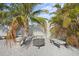 Backyard fire pit surrounded by benches and lush landscaping at 4440 Yacht Club Dr, Venice, FL 34293