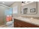Bathroom featuring a wood vanity, granite countertop, glass enclosed shower, and neutral tones at 4440 Yacht Club Dr, Venice, FL 34293