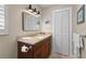 Bathroom featuring a dark wood vanity, granite countertop, and updated fixtures at 4440 Yacht Club Dr, Venice, FL 34293