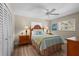Bedroom with wooden headboard, coastal-themed bedding, and wood-look flooring at 4440 Yacht Club Dr, Venice, FL 34293