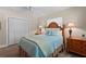 Cozy bedroom features a wooden bed frame, two side tables and a ceiling fan at 4440 Yacht Club Dr, Venice, FL 34293