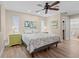 Cozy bedroom with a queen-sized bed, plantation shutters, and light green nightstands at 4440 Yacht Club Dr, Venice, FL 34293