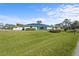 Well maintained front yard and home exterior with a lush lawn and solar panels on the roof at 4440 Yacht Club Dr, Venice, FL 34293