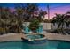 Backyard hot tub with seating area surrounded by lush greenery and palm trees at 4440 Yacht Club Dr, Venice, FL 34293