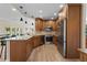 The remodeled kitchen features stainless appliances, wood cabinets, granite counters and hardwood flooring at 4440 Yacht Club Dr, Venice, FL 34293