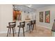 Kitchen with breakfast bar, granite counters, stainless appliances, wood cabinets and travertine flooring at 4440 Yacht Club Dr, Venice, FL 34293