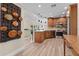 Well-equipped kitchen boasts stainless appliances, granite counters, wood cabinets and stylish hardwood flooring at 4440 Yacht Club Dr, Venice, FL 34293