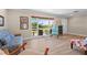 Bright living room featuring hardwood floors, large windows, and comfortable seating at 4440 Yacht Club Dr, Venice, FL 34293