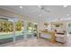 Bright living room with travertine floors, pool view, comfortable seating, and stylish coastal decor at 4440 Yacht Club Dr, Venice, FL 34293