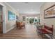 Open living room with hardwood floors, neutral paint, and a sliding glass door to the yard at 4440 Yacht Club Dr, Venice, FL 34293