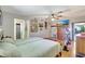 Bright bedroom features hardwood floors, a ceiling fan, and a flat screen television at 519 Bayview Ave, Osprey, FL 34229