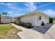 Side exterior of home featuring a detached garage, landscaping, and concrete driveway at 519 Bayview Ave, Osprey, FL 34229