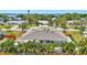Exterior shot of a single-Gathering home that features a nice roof with skylights and a well-kept yard at 519 Bayview Ave, Osprey, FL 34229