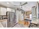 Open concept kitchen with stainless steel refrigerator and view of a dining area at 519 Bayview Ave, Osprey, FL 34229