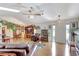 Open-concept living room featuring hardwood floors, a ceiling fan, comfortable seating, and natural light at 519 Bayview Ave, Osprey, FL 34229