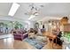 Open living area with cozy seating, fireplace, and view of the adjoining sunroom at 519 Bayview Ave, Osprey, FL 34229